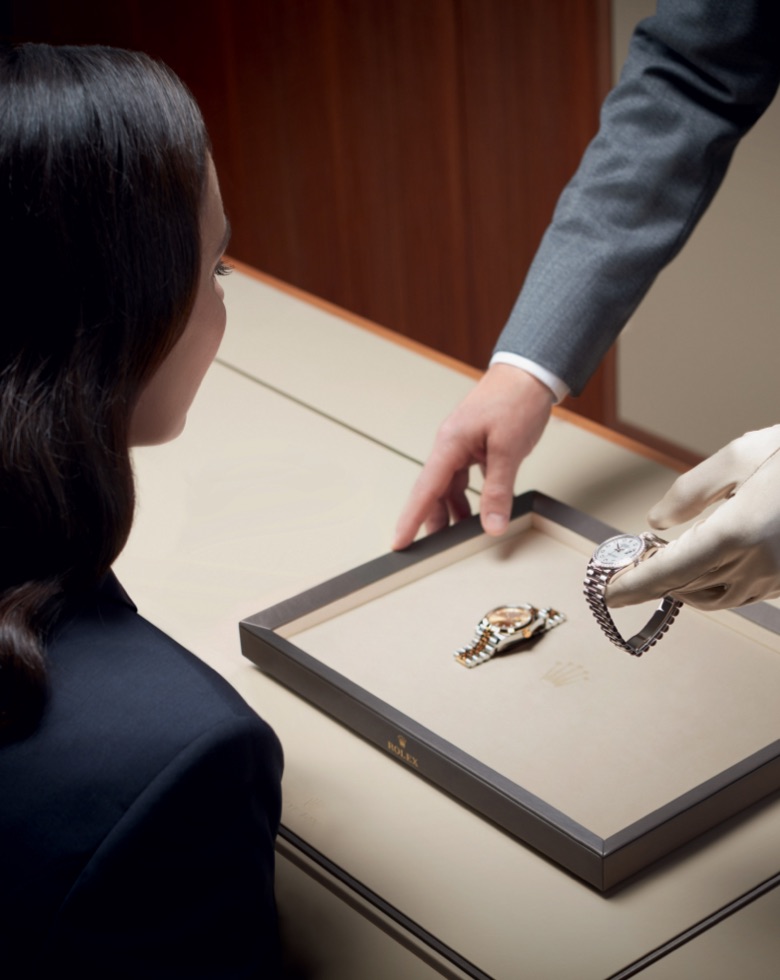 Women looking at a watch being serviced